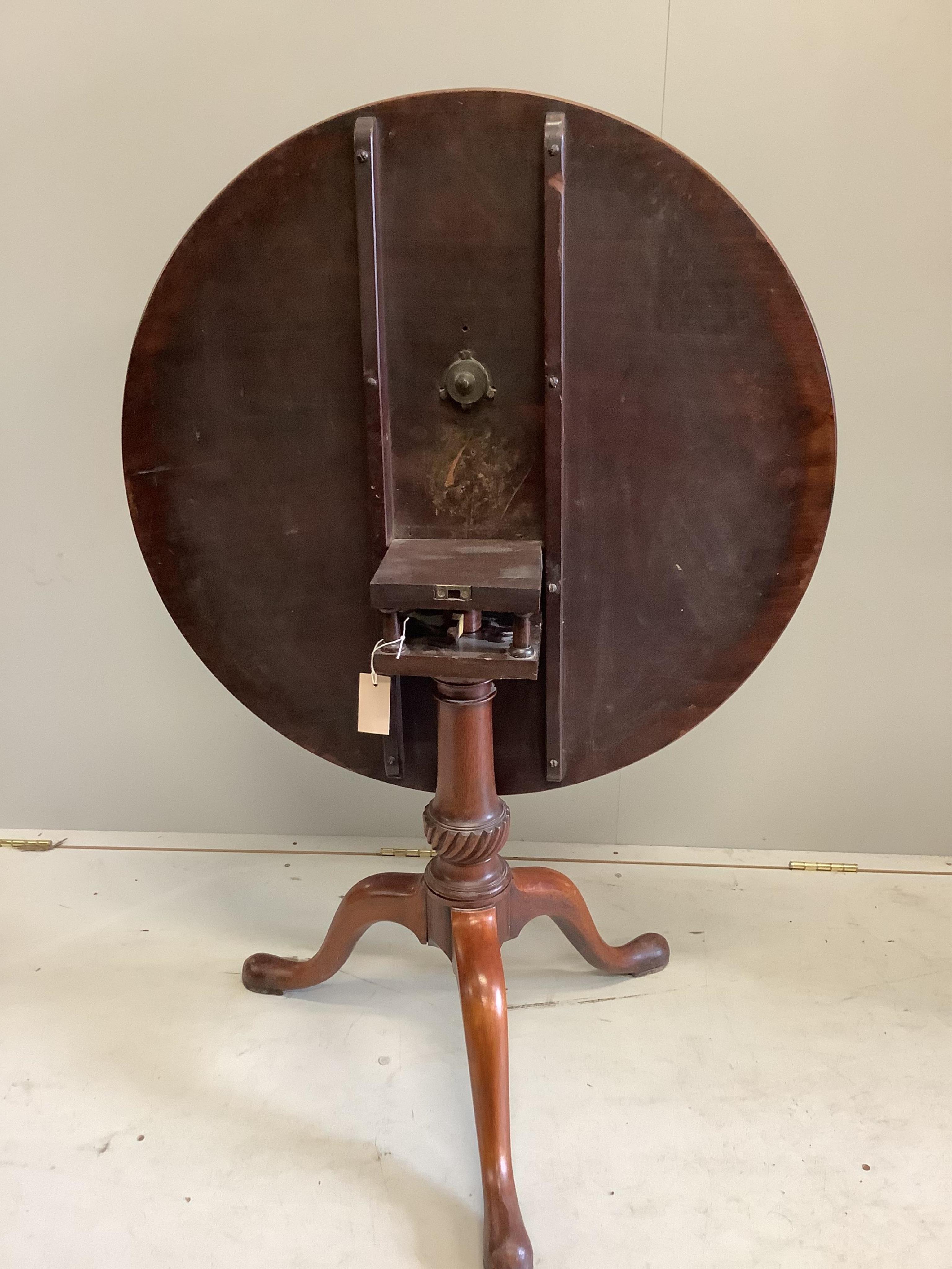 A George III circular mahogany tilt top bird cage tripod tea table, diameter 82cm, height 71cm. Condition - fair